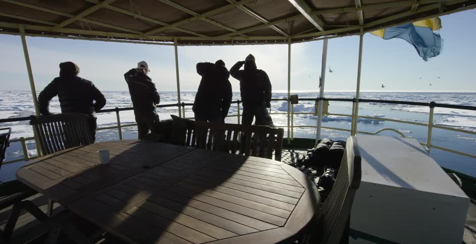 People standing near the railing of their ship