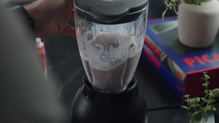 Blending chocolate smoothie in a blender