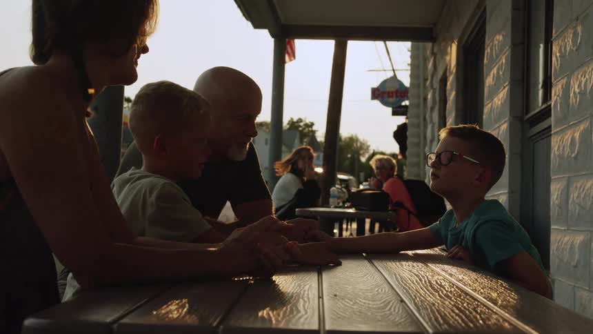 A family sit outside