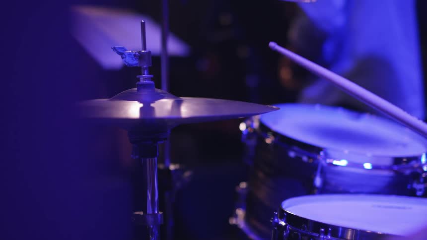 A drummer tapping cymbals