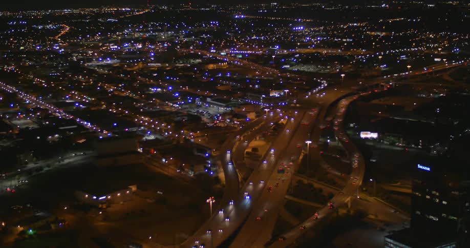 Vehicles drive on a busy city street