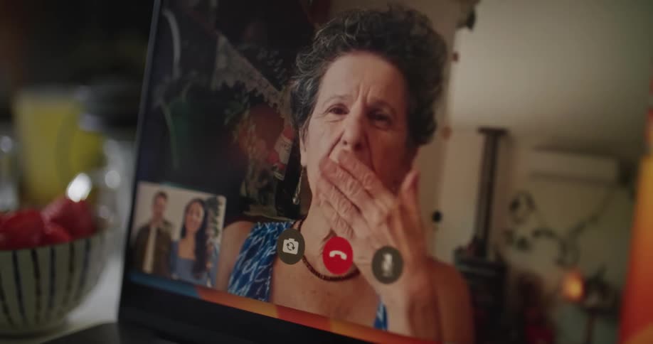 Mother in law on face time call with adult children waving goodbye and signing off