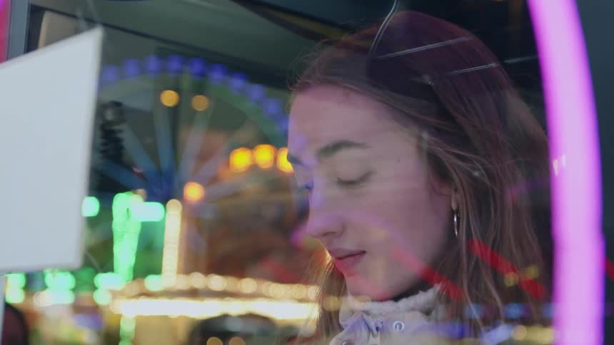 A teenager plays a game in a booth at a carnival