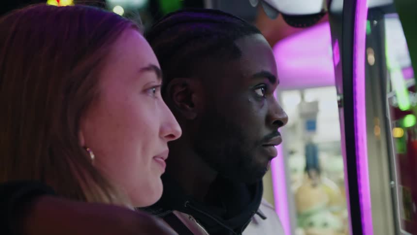 Man and woman together on a date looking at something in a store window