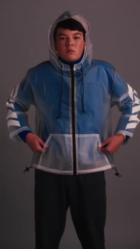 Man puts his hood up then puts his hands in the jacket pockets