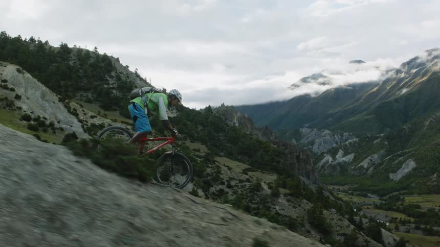 Mountain biking down a steep mountain slope