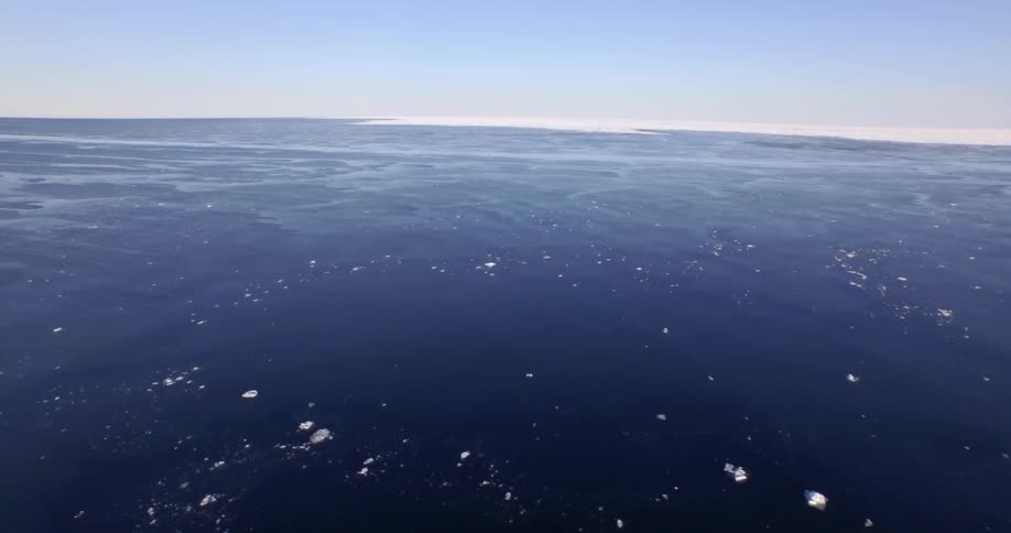 The water below has ice floating around