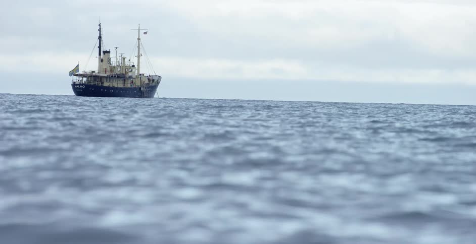 A large ship is sailing on a cloudy day