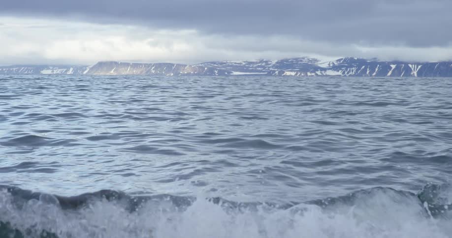 A choppy body of water on a cloudy day