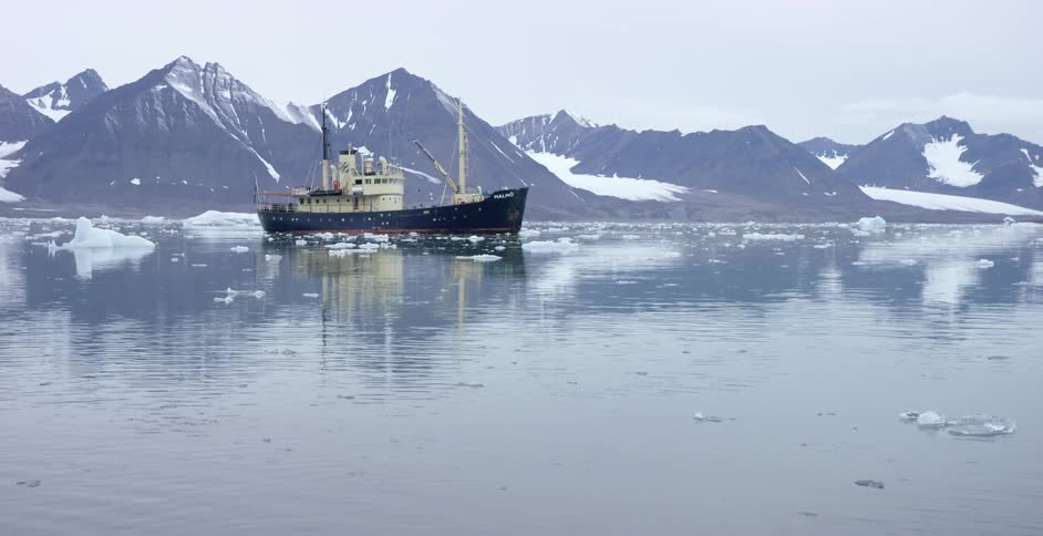A large ship is sailing in icy waters