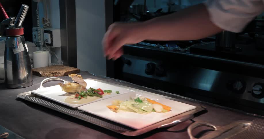 A person plates a meal