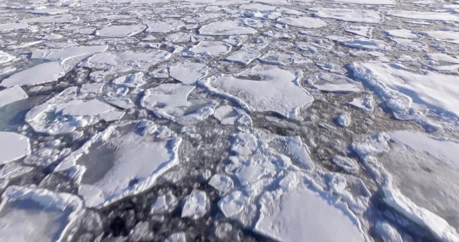 The water below is frozen with large pieces of ice all over