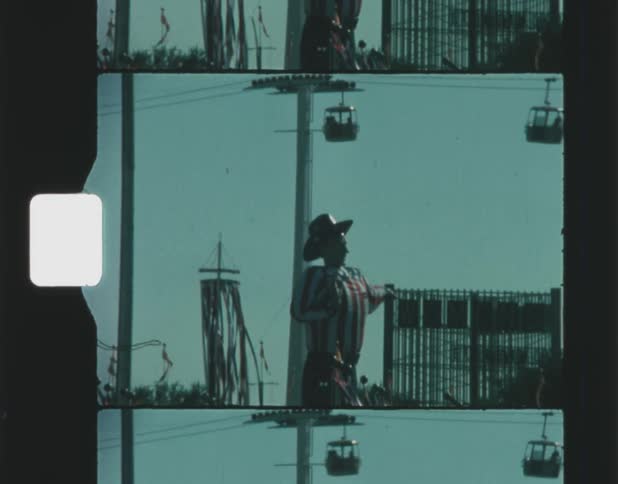 A large big tex statue is under the ski lift