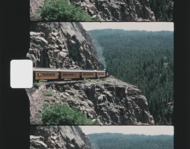 Vintage footage of train going around hairpin turn on mountain