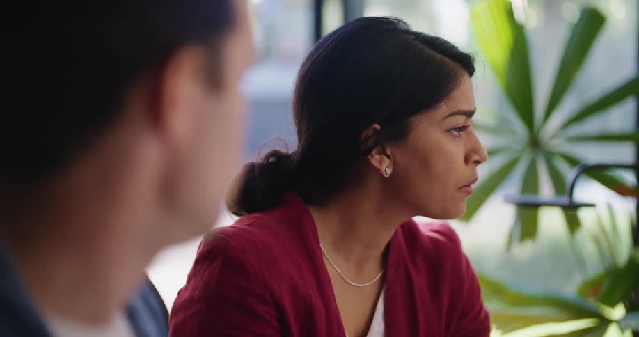 Two colleagues discuss graphs on a computer