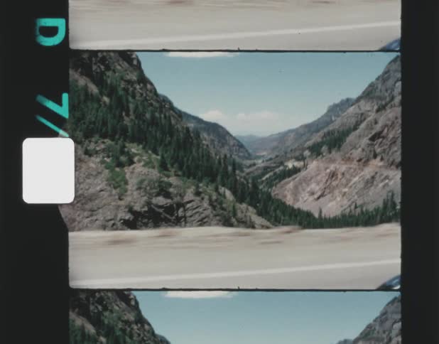 A highway runs along a vast canyon