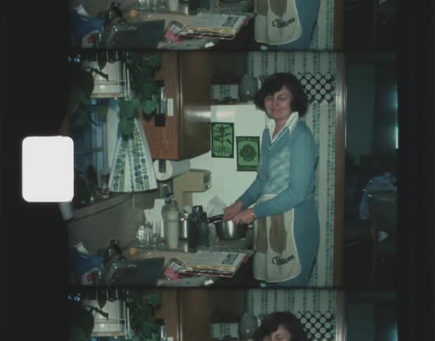 A woman washes a metal bowl in the sink