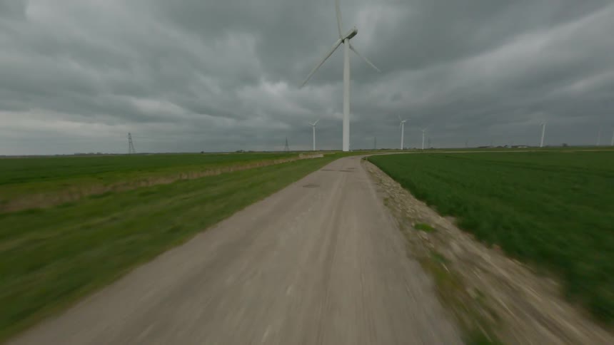 Wind turbines in a rural field on a cloudy day