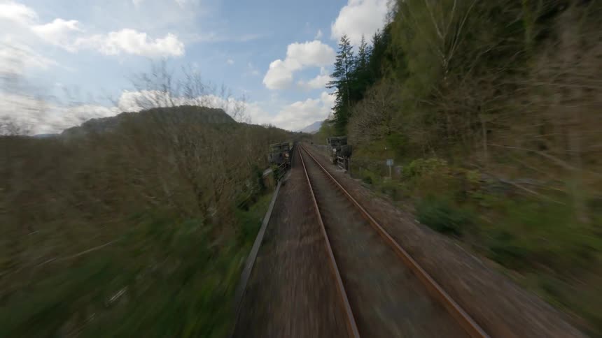 The car passes the empty train tracks