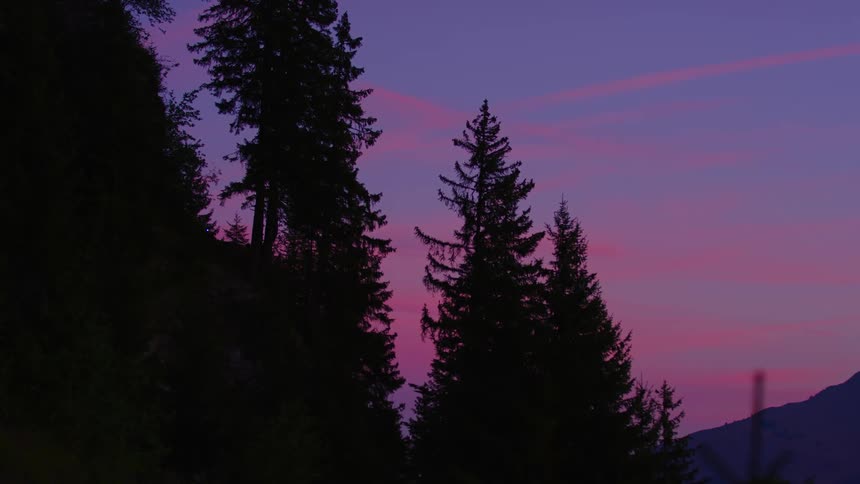 The silhouette of a cyclist in the distance is seen against a beautiful sky