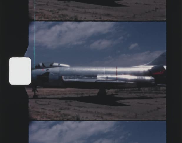 A jet plane parked outside on pavement
