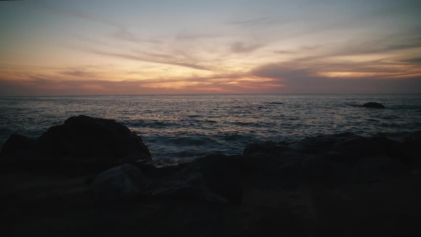 Waves lap against the shoreline at dawndusk
