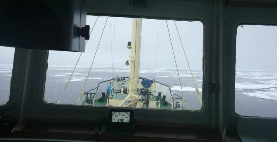 A ship sails in icy waters