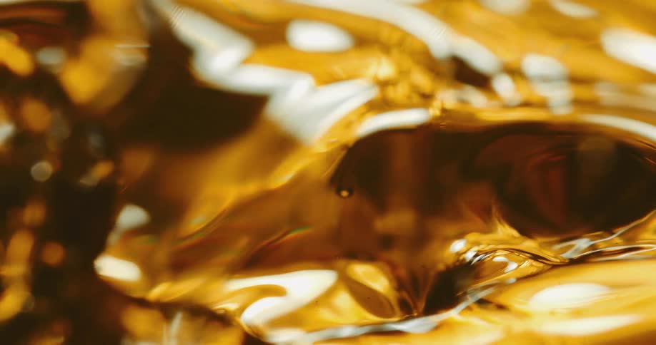 Close up of golden oil dropping