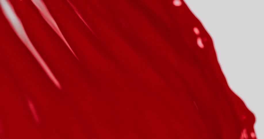 Red paint pouring down on a white background