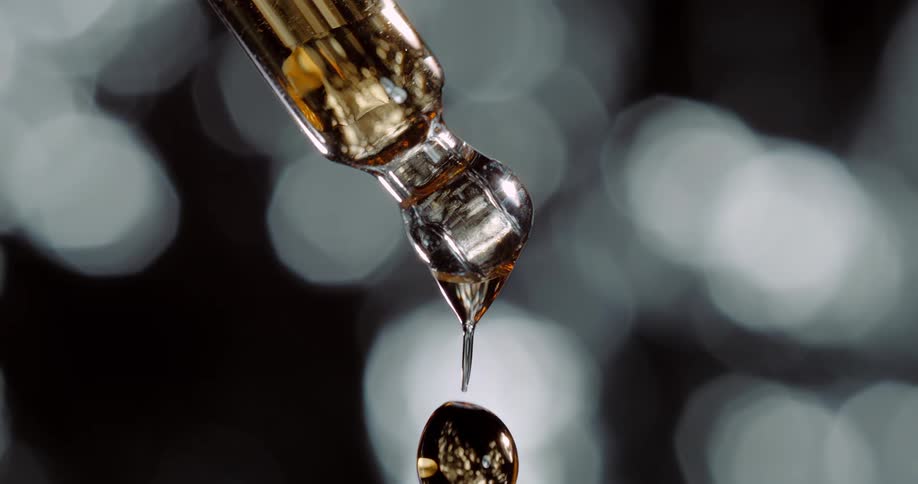 A drop falls from the vial