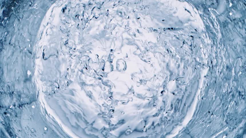 Rings of white circles are sitting on the surface as they sink underwater bubbles rise in the ripples as the water moves