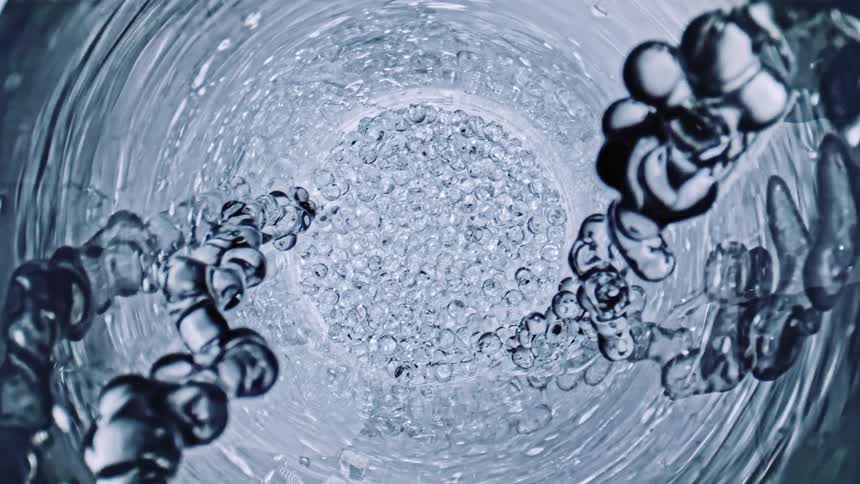 Water flowing down into glass