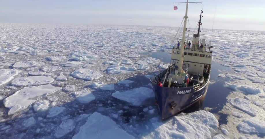 A boat is sailing through ice filled water