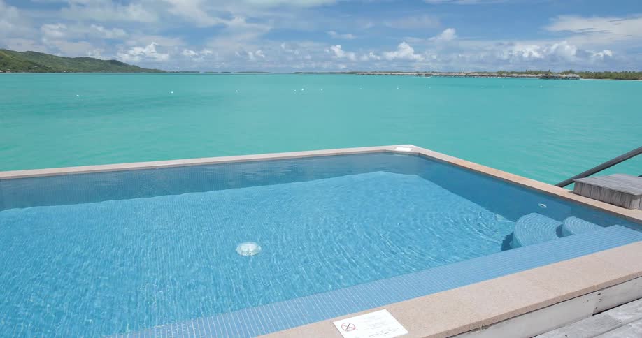 Resort pool right next to a beautiful bay