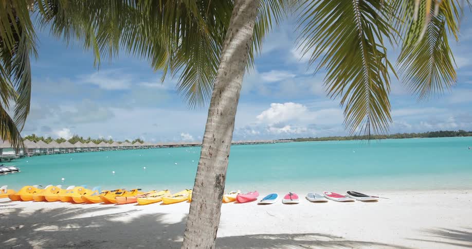 Canoes and boards line the beach empty