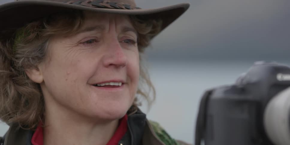 A woman is smiling looking at a camera