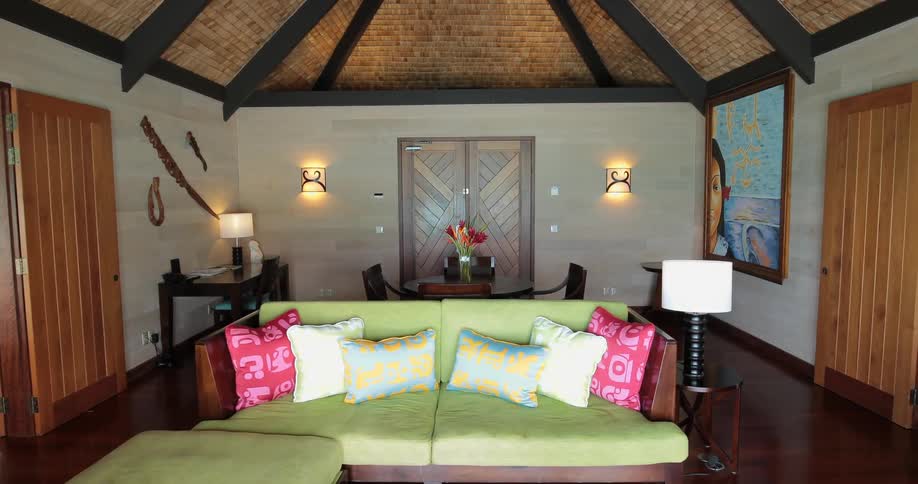 A living room has a couch and a door on each side