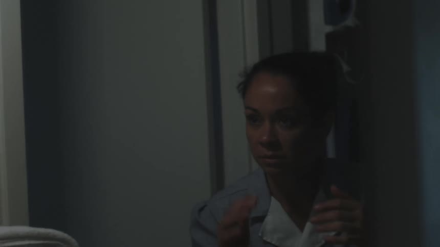 A housekeeper walking up to a mirror with towels placing them down and then moving around as if fighting