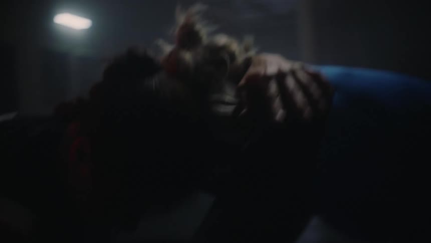 A blonde woman and a brunette woman furiously wrestle with each other