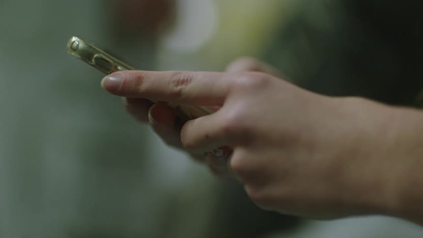 Close up of hands using mobile phone
