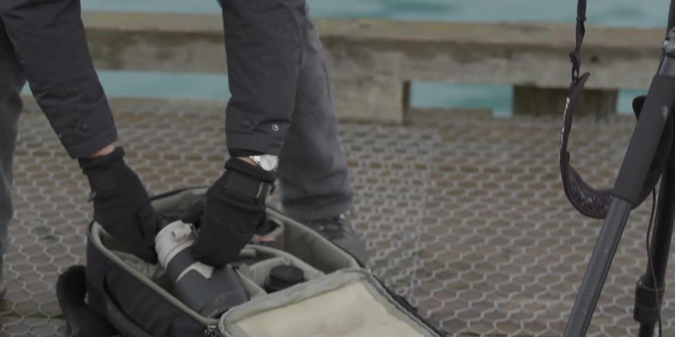 Photographer loading their equipment into a case