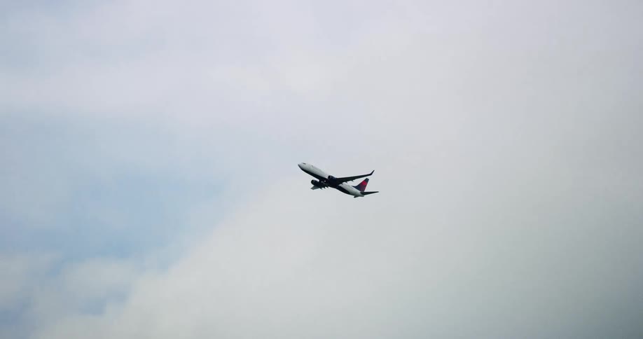 An airplane is flying in the sky during midday