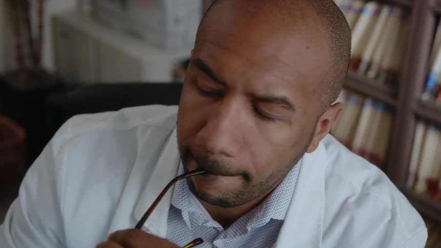 A man is sitting down and thinking in his office