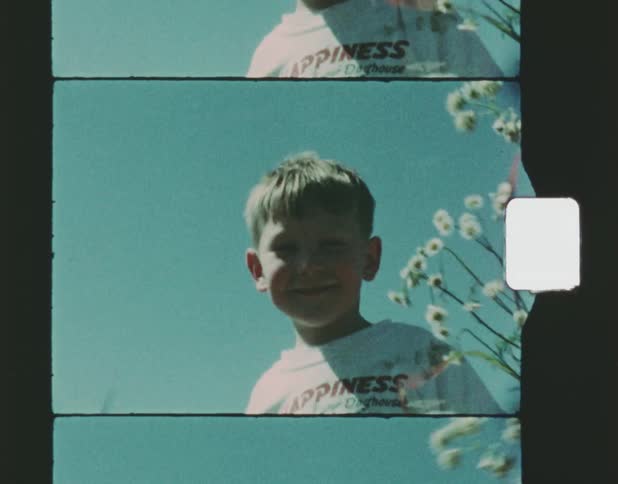 A little boy looking at the camera and laughing joyfully