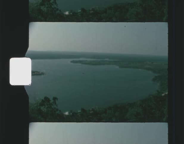 A large body of water can be seen captured on a old film footage