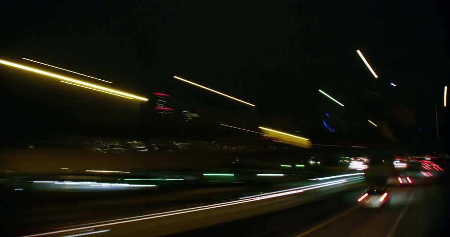 A time lapse of traffic driving towards the city at night