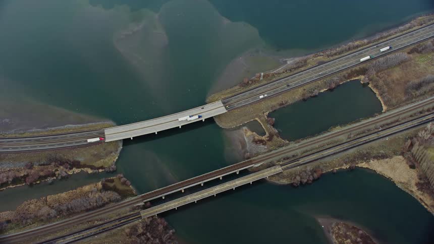 An aerial of a highway bridge going over a waterway connected to the ocean