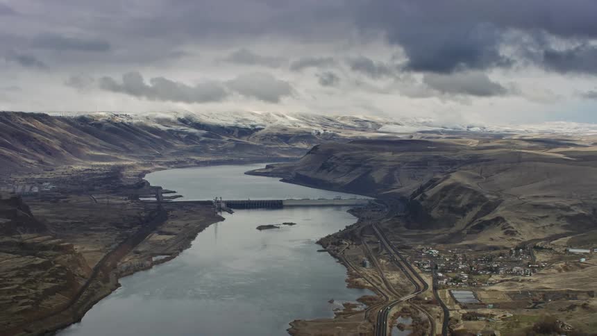 A large amount of water is held behind a dam on a cloudy day