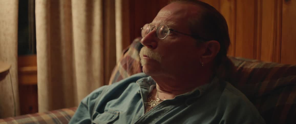 A man sits on a sofa at home
