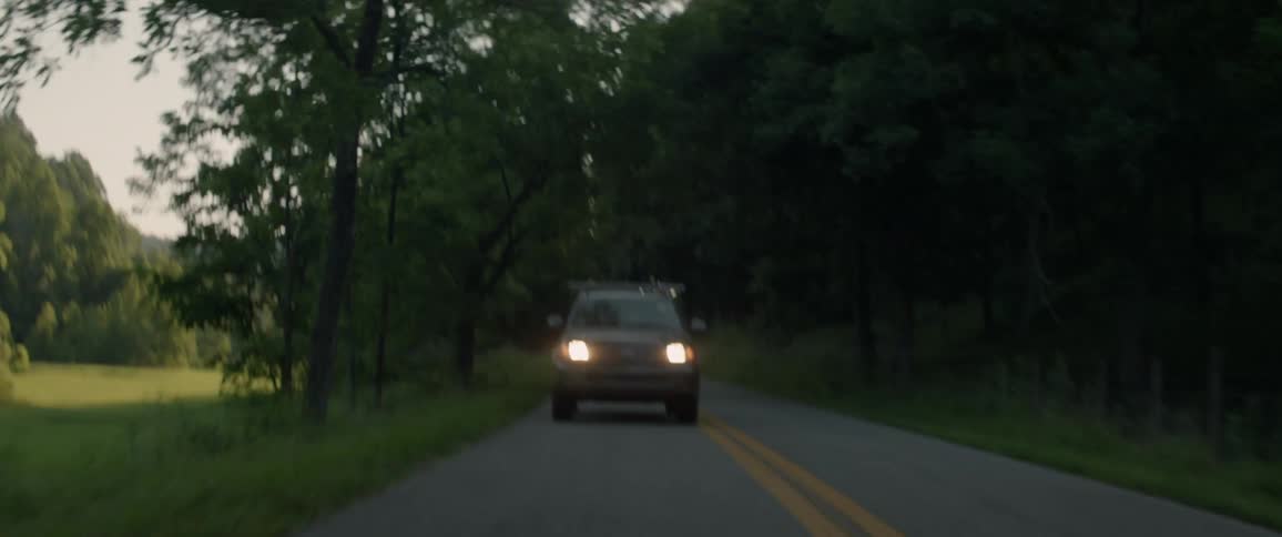 A truck drives on the rural road